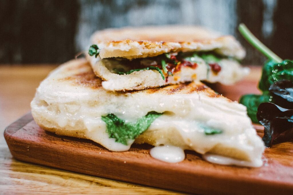 pexels photo 1885578 Delicious grilled panini loaded with melted cheese and fresh spinach, perfect for a satisfying meal.